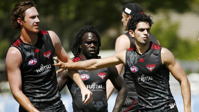 Mitch Brown (left), Anthony McDonald-Tipungwuti and Jake Long sitting tight at Essendon training. Picture: Colleen Petch