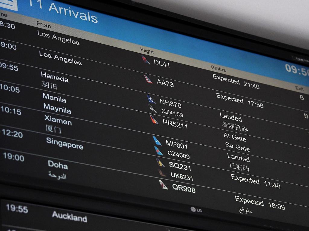 A digital board showing international flight arrivals at Sydney International Airport in February. Picture: Bianca De Marchi