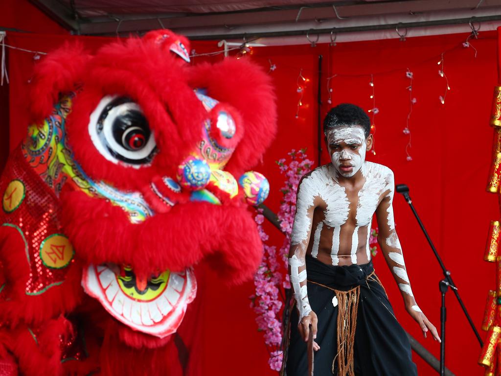 Jeff Daniels of the Minjil dance group dance with a CADCAI lion at the Cairns and District Chinese Association Inc Chinese New Year street festival on Grafton Street. PICTURE: BRENDAN RADKE