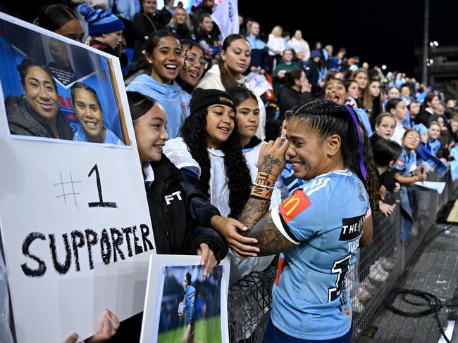 Sarah Togatuki embraces her family. Picture: NRL Photos
