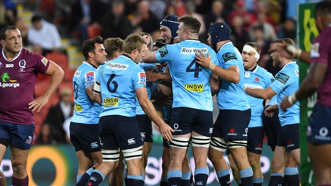 Waratahs players celebrate a try on Saturday night.