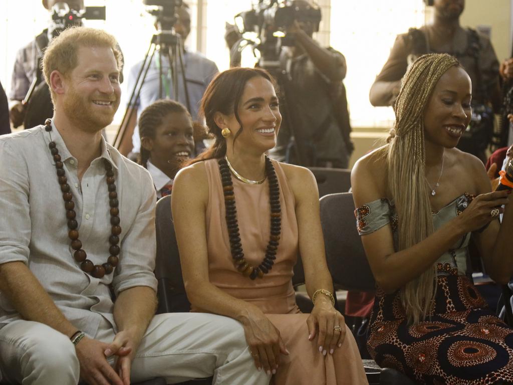 The couple beamed as they took part in cultural activities. Picture: Andrew Esiebo/Getty Images for The Archewell Foundation