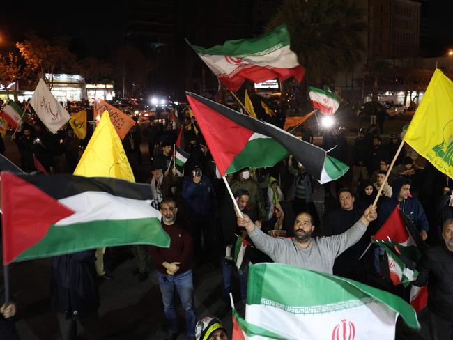 Iranians wave Palestinian, Hezbollah and national flags as they celebrate the news of a ceasefire and hostage release deal. Picture: AFP