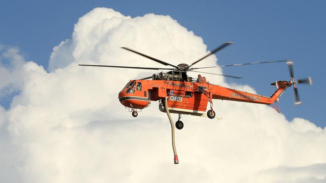 A helicopter attends to the blaze at Rosedale. Picture: Mark Stewart