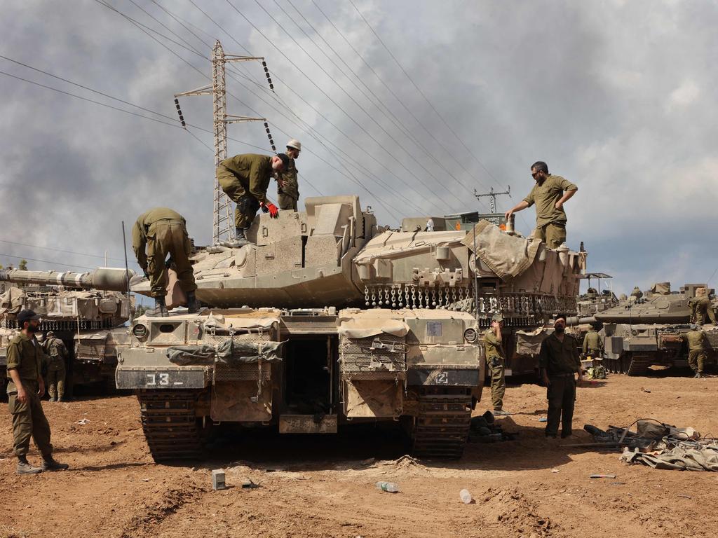 Israeli troops prepare weapons and armed vehicles near the southern city of Ashkelon. Picture: AFP)