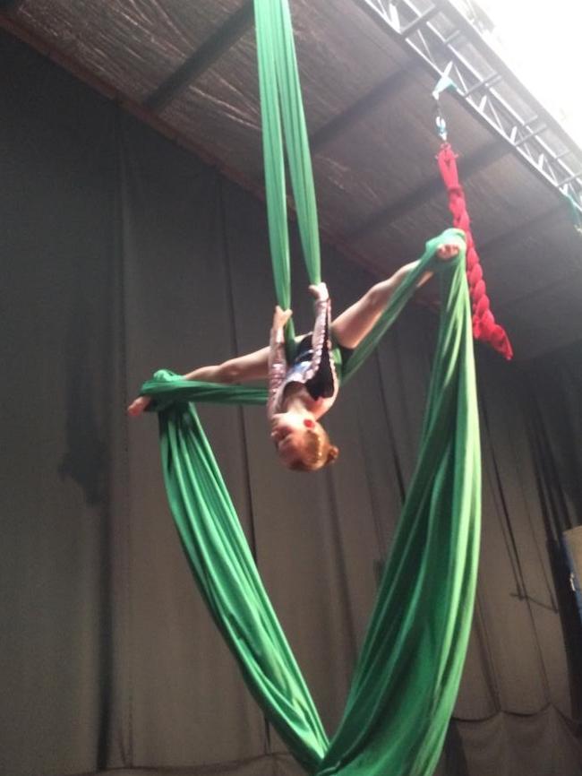 A girl works on her silks technique.