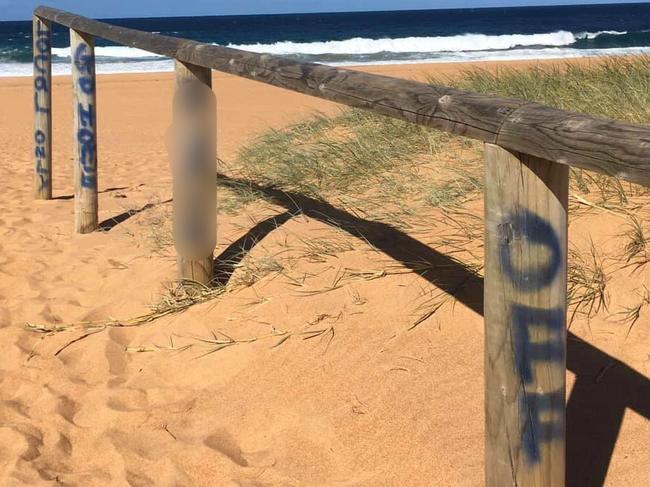 A blunt spray painted "locals only" message on a walkway leading to North Narrabeen Beach. Picture: Facebook