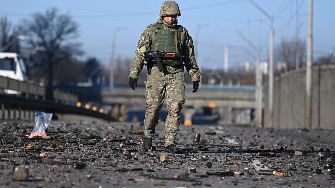 An Ukrainian soldier walks through debris on the west side of the capital Kyiv on February 26, 2022. Picture: Daniel Leal/AFP