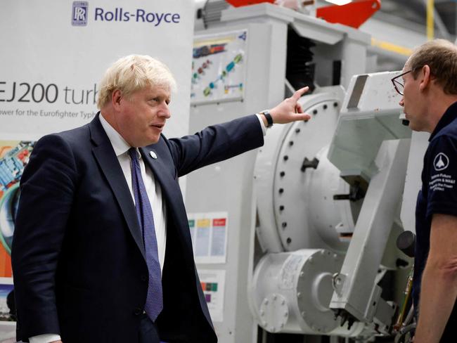 Britain's Prime Minister Boris Johnson (L) gestures during his visit to the Rolls Royce factory in Bristol on October 15, 2021, ahead of chairing a regional cabinet meeting in the city later in the day. (Photo by JOHN SIBLEY / POOL / AFP)