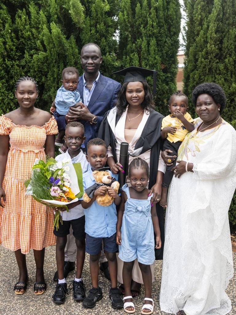 Bachelor of Commerce and Bachelor of Business graduate Mary Ngor with family (from left) Adut Ngor, Kun Kun holding Akech Malueth, Malueth Malueth, Nai Malueth, Aluel Malueth and Sarah Duot holding Abuk Malueth at the UniSQ graduation ceremony at Empire Theatres, Tuesday, December 13, 2022. Picture: Kevin Farmer