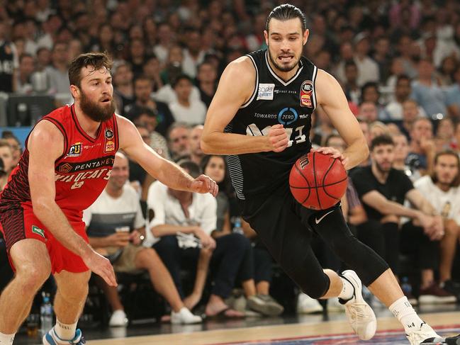 Chris Goulding under pressure from Mitch Norton (left) of Perth. Picture: AAP