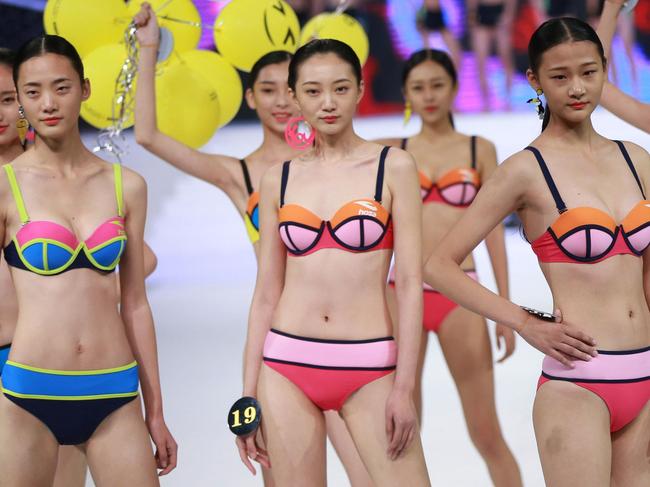 This photo taken on December 16, 2016 shows models competing in the China Fashion Model Contest Finals in Sanya on China's southern Hainan Island. The contest, organised by the China Fashion Designers Association, featured over 40 male and female contestants from across China. / AFP PHOTO / STR / China OUT