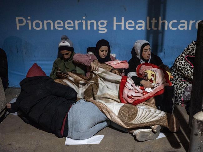 People displaced by announcements of Israeli airstrikes shelter at the entrance to a Beirut medical centre on November 26. Picture: Ed Ram/Getty Images