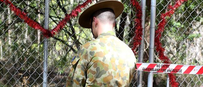 A soldier locks the gate to Killarney Glen. Photo: Regi Varghese.