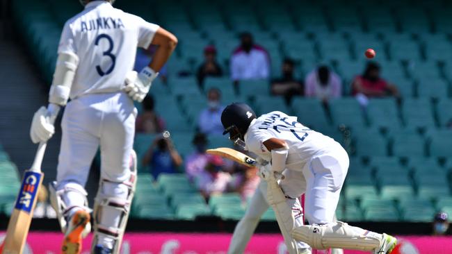 Indian batsman Cheteshwar Pujara ducks to avoid bouncer off Australian paceman Mitchell Starc. Picture: Saeed Khan/AFP