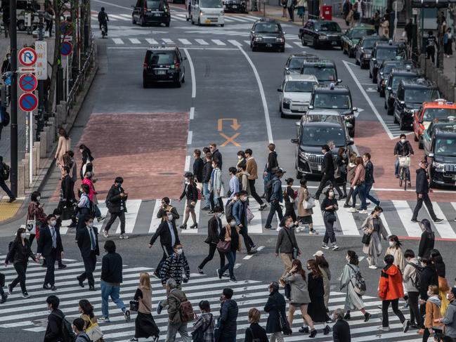 TOKYO, JAPAN - APRIL 03: People, some wearing face masks, cross a road in Shibuya on April 03, 2020 in Tokyo, Japan. Although Japan has so far been spared the explosive surge of Covid-19 coronavirus infections seen in some European countries, Prime Minister Shinzo Abe is coming under increased pressure to take tougher measures to tackle the rising infection rate in the country. Tokyo continues to have the highest number of infections of any prefecture with 684 cases although it remains a comparatively small figure compared to the citys 14 million population. (Photo by Carl Court/Getty Images)