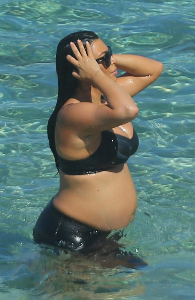 Kim kept her shades on as she swum with her sisters in St. Barts.