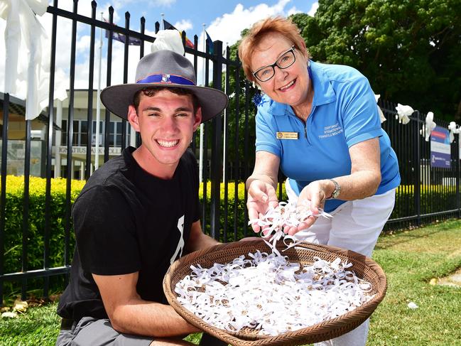 Ignatius Park College year 11 student Wayne Owens, 16, holds the 1100 white ribbons which Soroptimist Group volunteer Janet Askern made with the help of fellow group members. Picture: Shae Beplate.