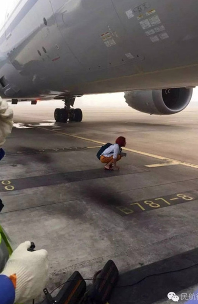 Woman blocks plane on runway. Picture: WeChat