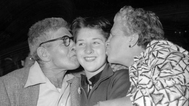 Family bond: Dawn Fraser with her parents, Kenneth and Rose, after she won her first Olympic Games gold medal in the 100m freestyle at the 1956 Melbourne games.