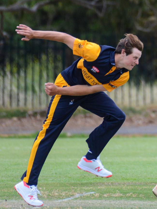 West Torrens bowler Isaac Johnson runs past Jake Hartigan sends one down. Picture: AAP Image/ Brenton Edwards