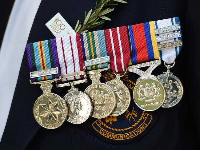 Medals are seen worn by an ex-serviceman during the Anzac Day march in Sydney, Monday, April 25, 2016. This year marks the 100th anniversary of the first Anzac Day service. (AAP Image/Dan Himbrechts) NO ARCHIVING