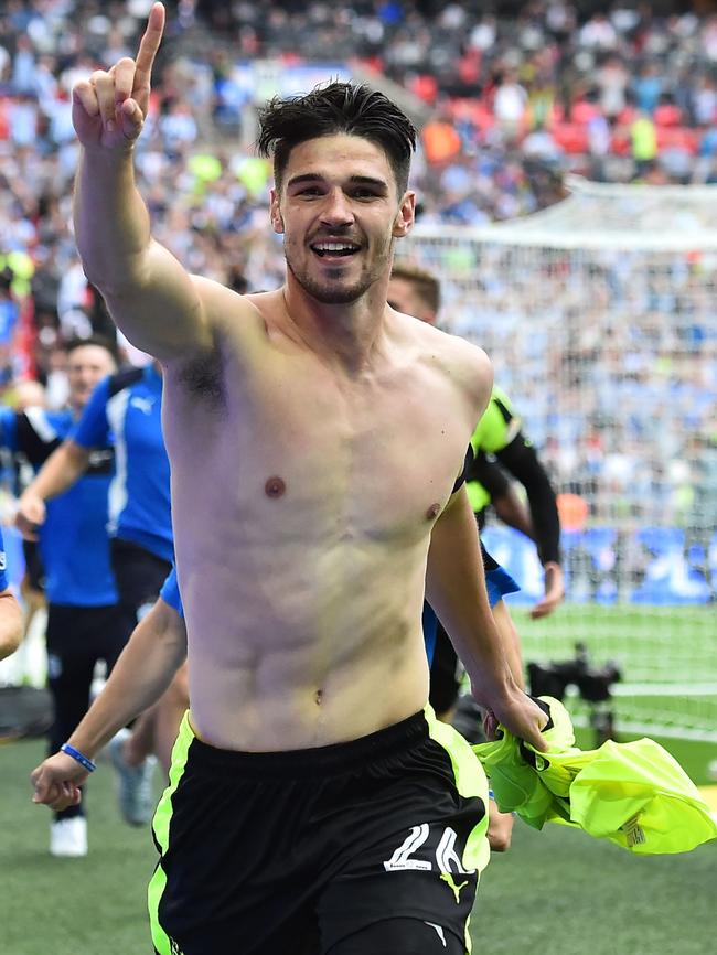 Huddersfield Town's German defender Christopher Schindler (R) celebrates with teammates/