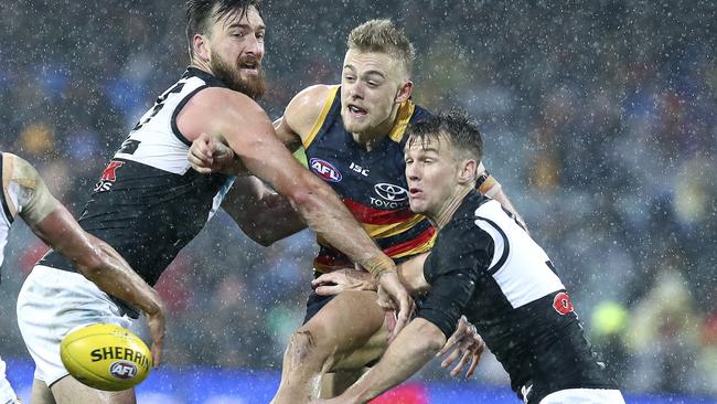 Hugh Greenwood gets his kick away under heavy pressure from Charlie Dixon and Robbie Gray. Picture Sarah Reed