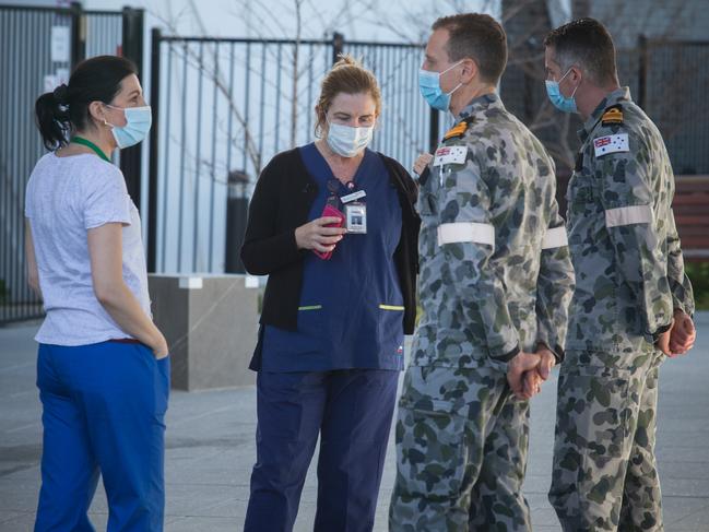 Australian Defence Force and Epping Gardens Nursing Home staff speak outside the facility yesterday. Picture: Paul Jeffers