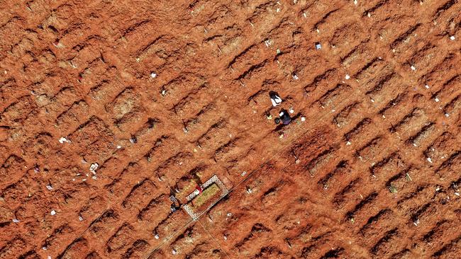 A family visit a grave at the Pedurenan Covid-19 coronavirus cemetery in Bekasi, West Java, on Wednesday. Picture: AFP