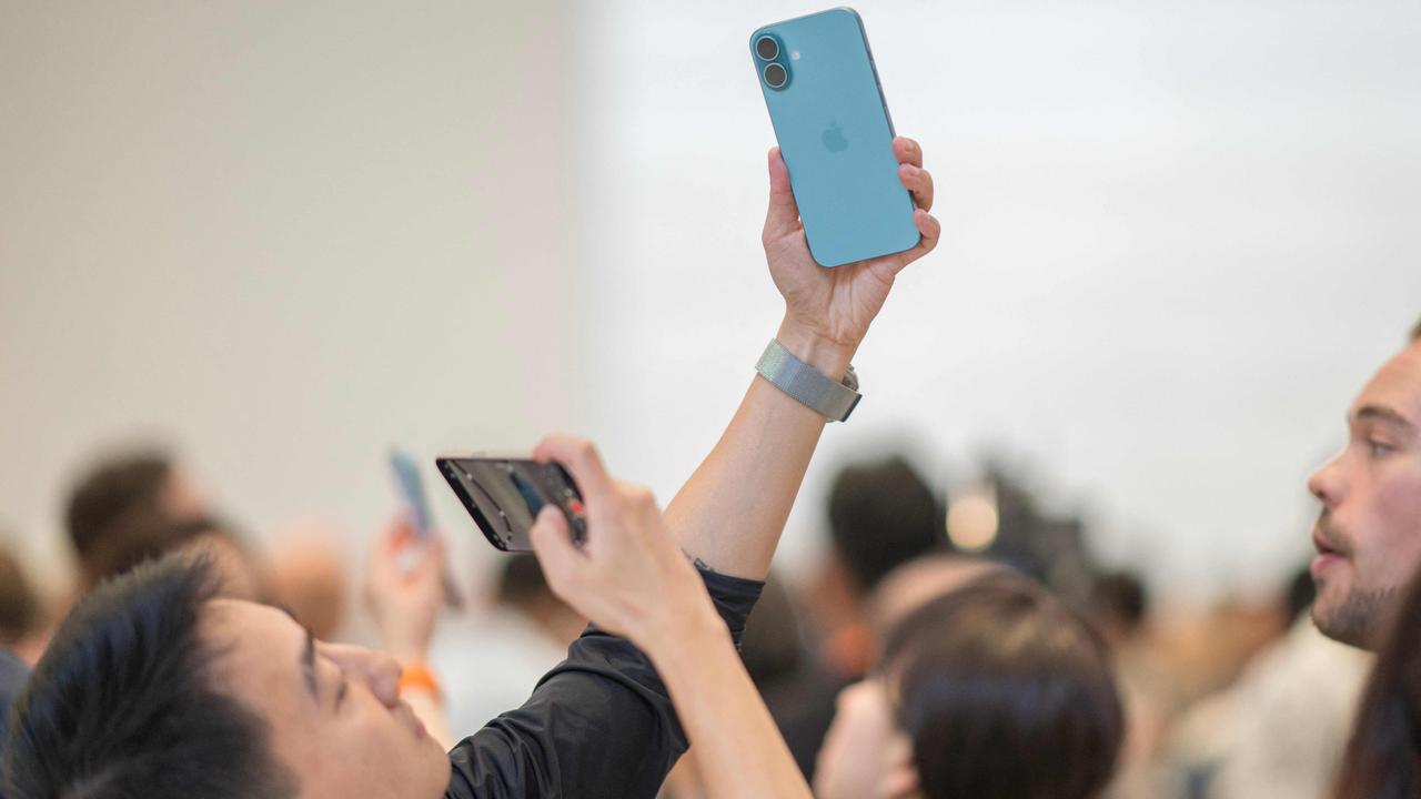 A man takes a photo of an iPhone 16 Pro following Apple's 'It's Glowtime' event in Cupertino, California on September 9. Picture: AFP