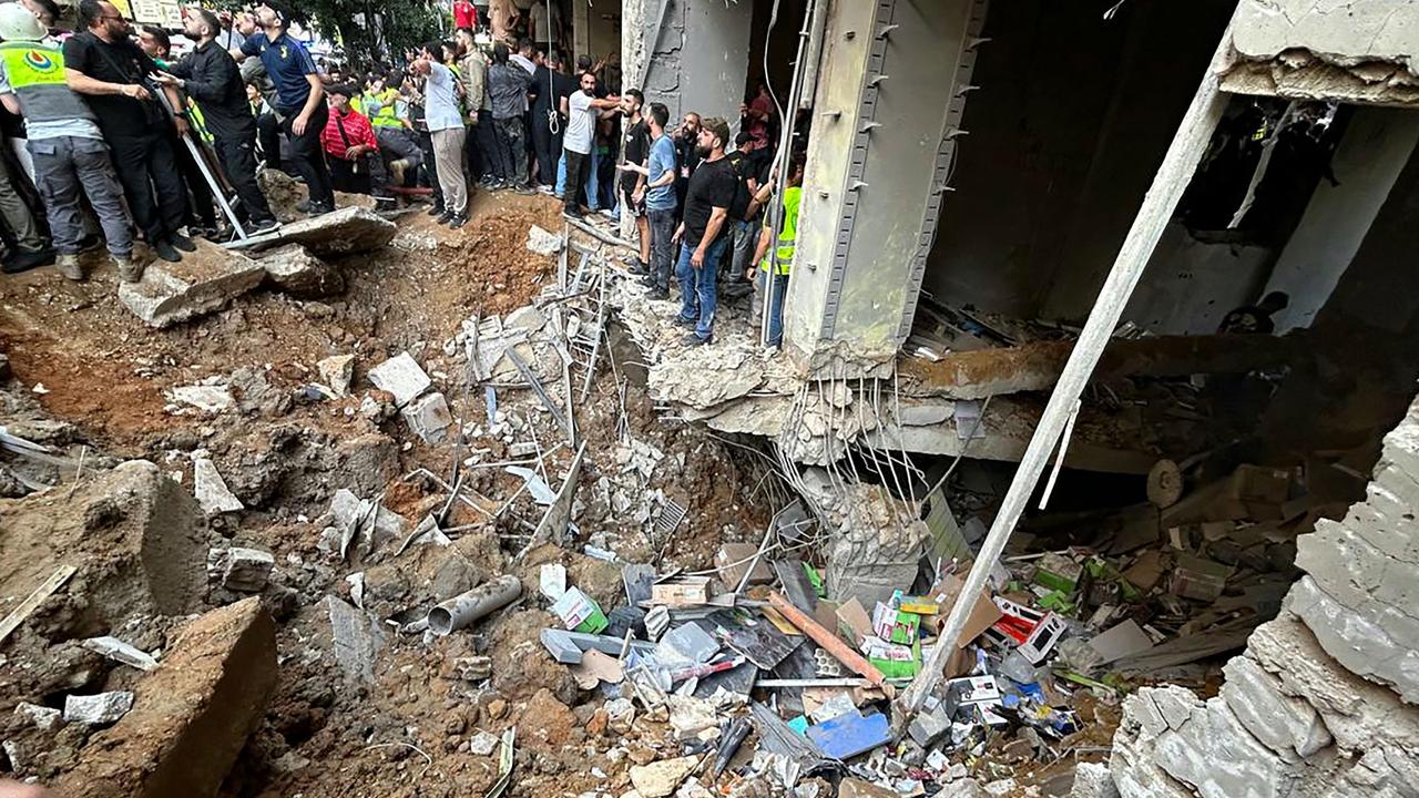 People check the damage at the site of an Israeli strike in Beirut's southern suburbs on September 20, 2024. (Photo by Anwar AMRO / AFP)