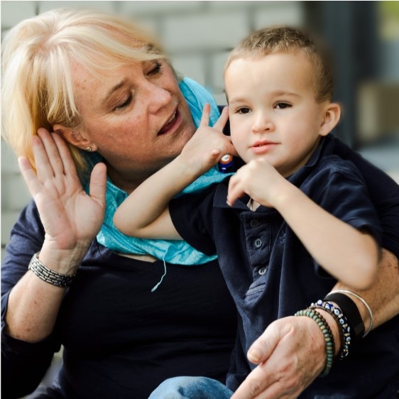 Disability services manager Fiona Phipps with Darcy Nunan, the first child in Royal Far West's "Windmill" Disability Program in 2015. He is using sign language for the first time and he is saying "I hear". Picture: Michael Mannington