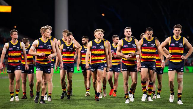 Adelaide players leave the ground after their loss to Essendon on Friday night. Picture: Daniel Kalisz (Getty).