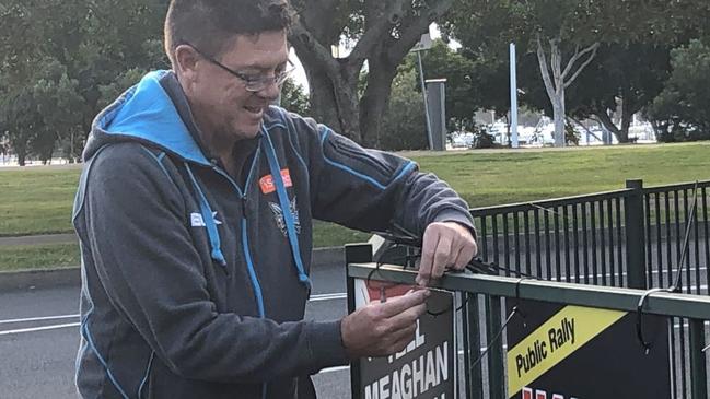 Southport MP Rob Molhoek putting up placards in Carey Park.