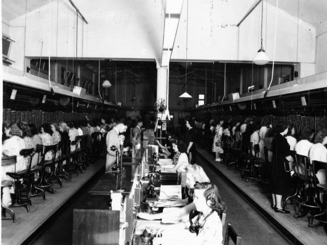 Telephone switchboard operators connect calls in the central exchange room in 1948. The room was in the General Post Office building on King William St.