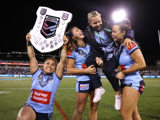 Kylie Hilder head coach of the Blues is chaired by Jessica Sergis and Isabelle Kelly. Picture: Cameron Spencer/Getty Images