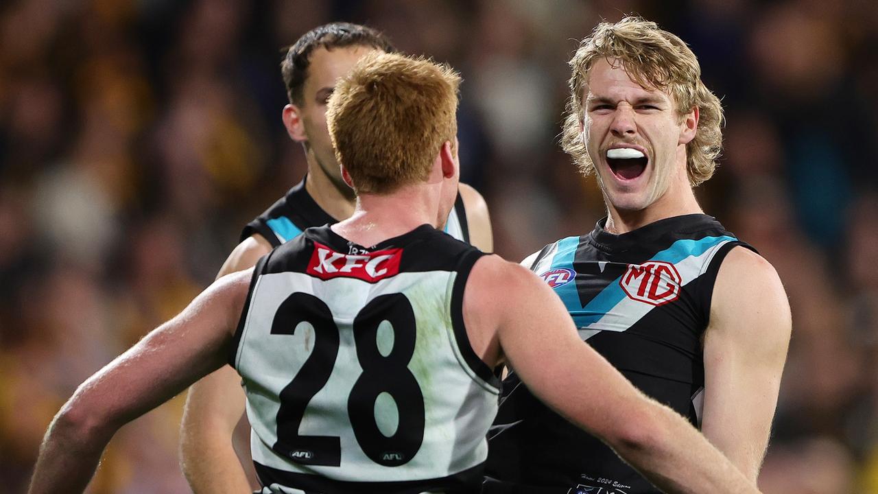 ADELAIDE, AUSTRALIA - SEPTEMBER 13: Jason Horne-Francis of the Power celebrates a goal with team mates during the 2024 AFL Second Semi Final match between the Port Adelaide Power and the Hawthorn Hawks at Adelaide Oval on September 13, 2024 in Adelaide, Australia. (Photo by Sarah Reed/AFL Photos via Getty Images)