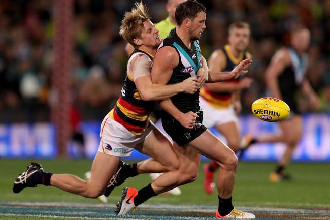 Crows co-captain Rory Sloane tackles Power’s stand-in captain Travis Boak in Showdown 46 at Adelaide Oval. Picture: James Elsby/Getty