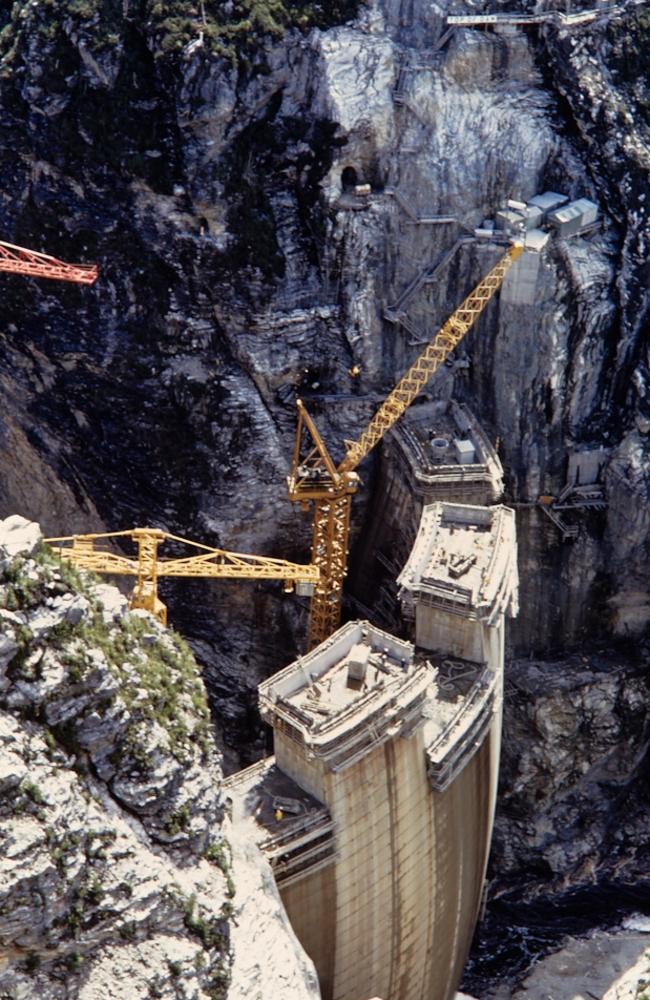 Engineer Mike Wallis who has clocked up 60 years with Hydro Tasmania and Entura. He was involved in construction of the Gordon Power station and dam – shown here during construction in the 1970s. Picture: Phil O'Halloran/ Hydro Tasmania