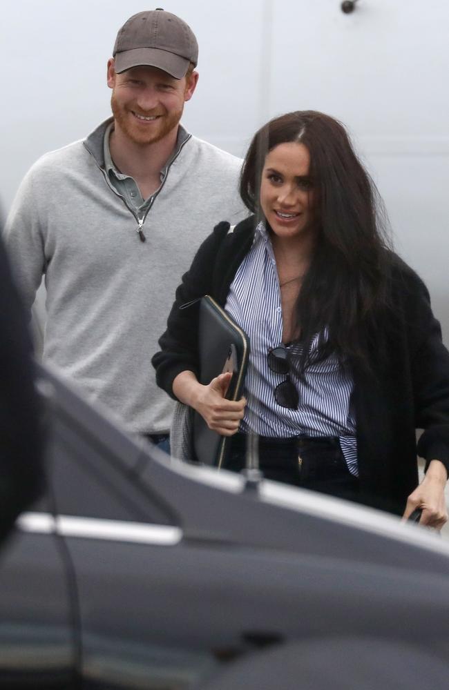 The couple were all smiles as they stepped off the plane. Picture: Backgrid