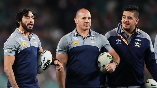 Injured Cowboys players Johnathan Thurston (L) and Matt Scott (R) assist Cowboys warm up.