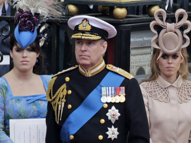 Andrew and his daughters Eugenie, left, and Beatrice leave Westminster Abbey at the wedding of Prince William to Catherine Middleton. Picture: AP