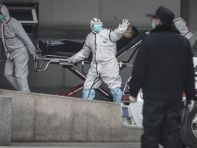 Medical staff transfer patients to Jin Yintan hospital in Wuhan. Picture: Getty Images