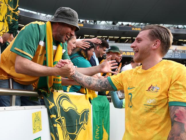 Socceroos goalscorer Jason Cummings is congratulated by a fan after Australia’s win. Picture: Fiona Goodall/Getty Images