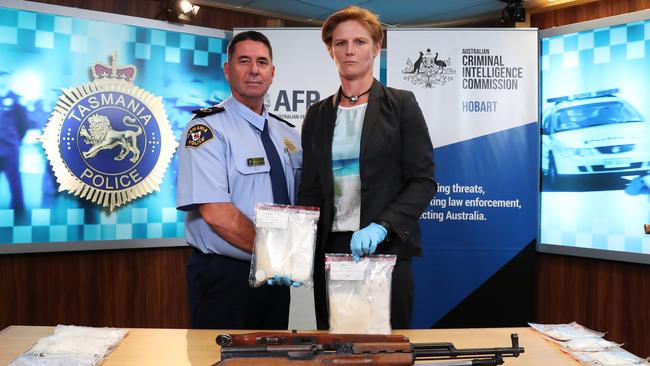 Assistant Commissioner Operations Richard Cowling and Detective Inspector Kate Chambers with drugs and firearms seized. Picture: NIKKI DAVIS-JONES