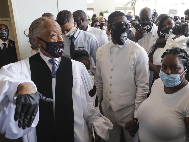 The Rev. Al Sharpton prepares to lead the family of George Floyd into the church. Picture: AP