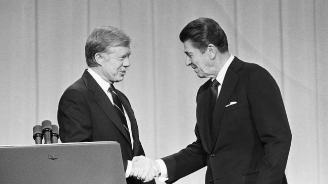 Jimmy Carter and his Republican challenger, Ronald Reagan, shake hands as they greet one another before their debate on the stage of the Music Hall in Cleveland, Ohio, 1980.