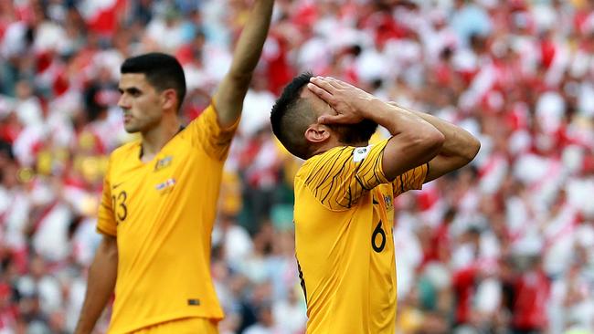 Socceroos players react during the 2-0 loss at the hands of Peru.