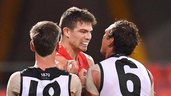 Zak Butters and Steven Motlop get in the face of Sam Collins. Picture: AAP Image/Darren England.